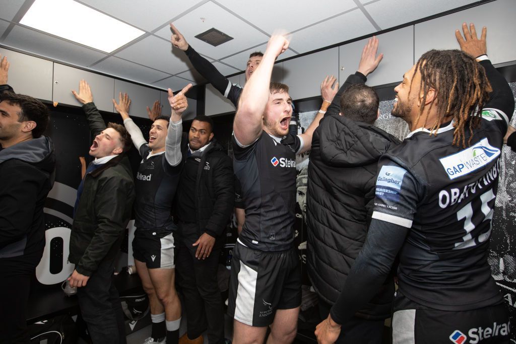 Newcastle rugby players celebrating in the dressing room