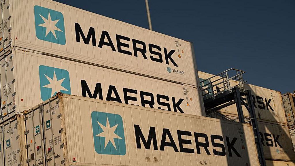 A stack of shipping containers with Maersk signs on the side