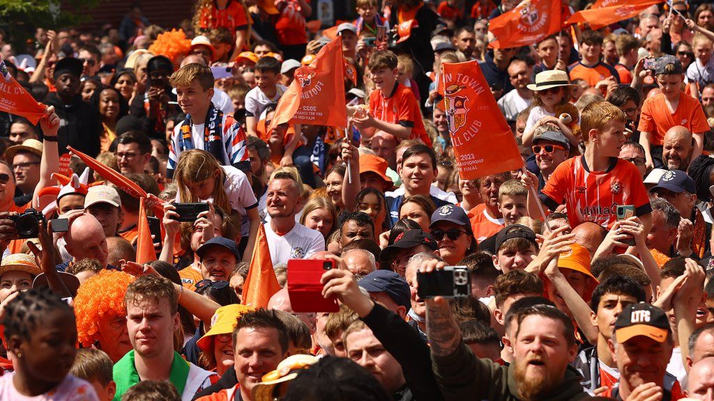 Luton Town fans celebrating in St George's Square in the town