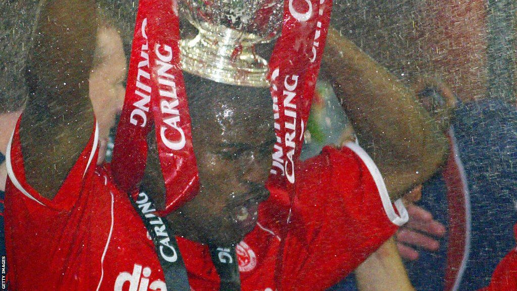 George Boateng holds a trophy on his head