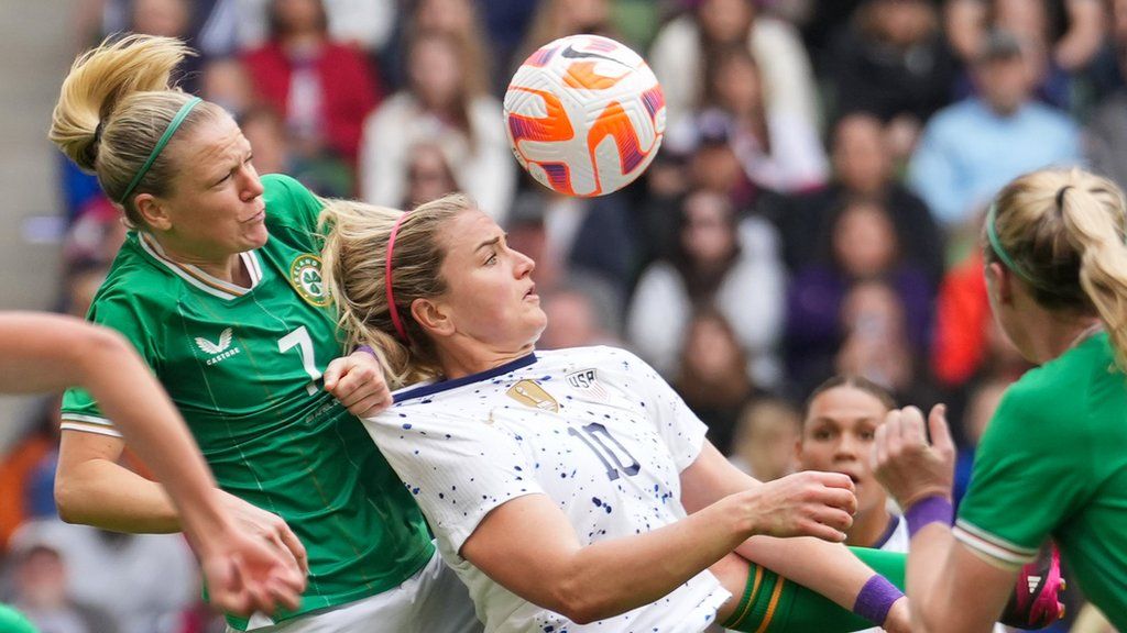Diane Caldwell gets hold of Lindsay Horan's short to concede the penalty