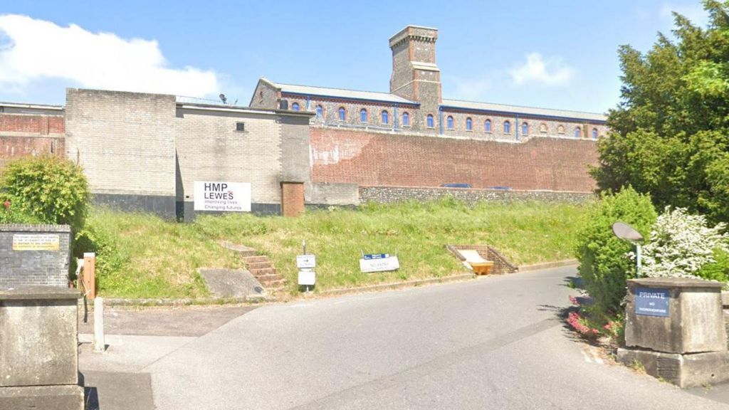 A Google maps image of a high brick wall surrounding the exterior of Lewes Prison in East Sussex. 