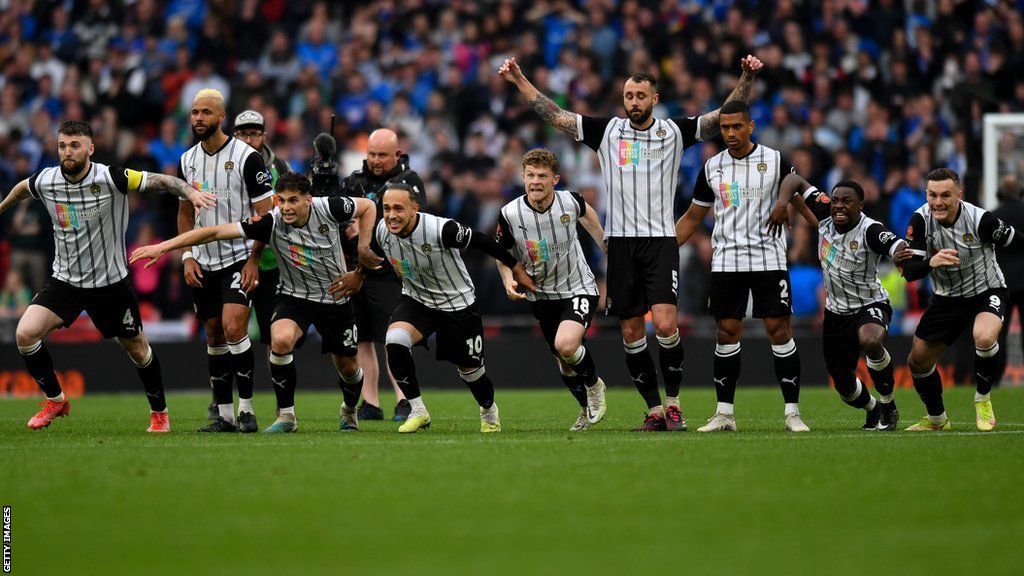 Notts County players on the halfway line at Wembley as they celebrate the winning penalty being scored in the National League promotion final against Chesterfield