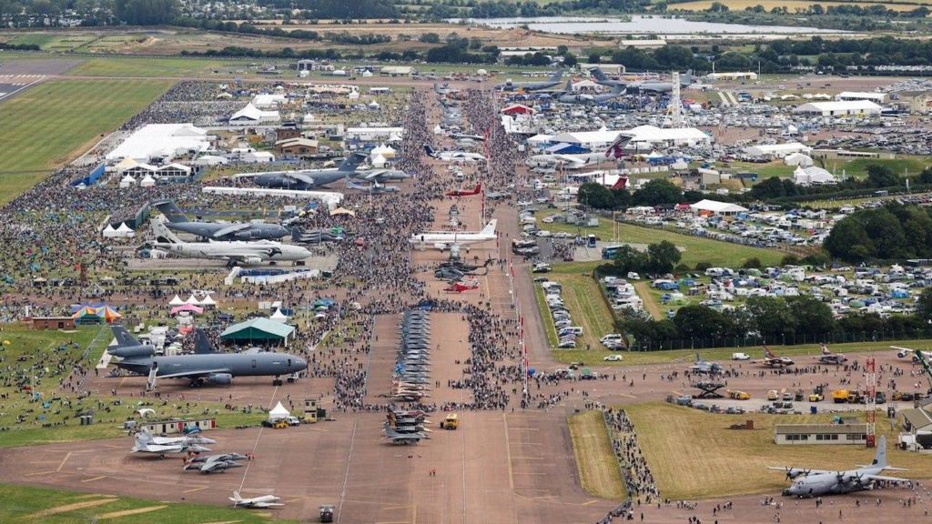 Overhead shot of the airfield packed full of visitors and planes