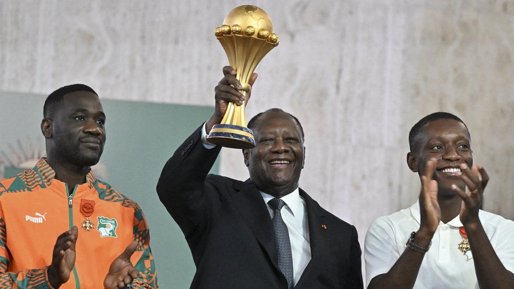 Emerse Fae, Ivorian President Alassane Ouattara and Max Gradel at a presentation