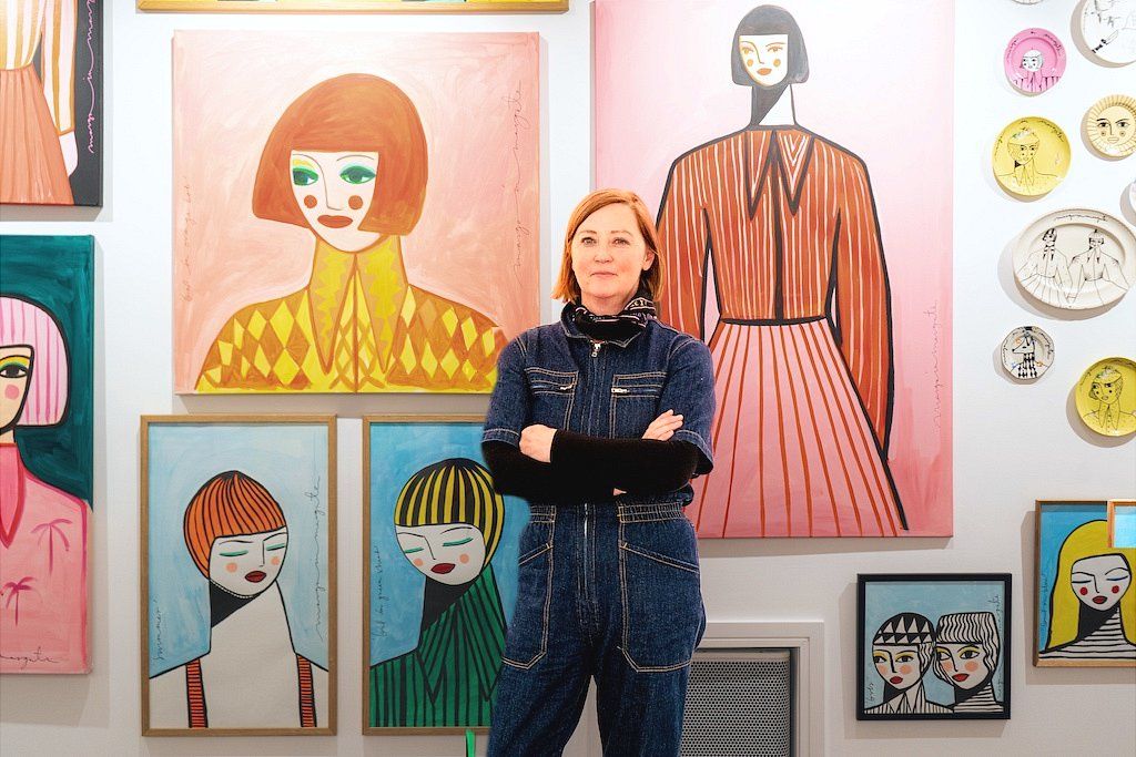 Margo McDaid poses with her paintings at Helm Gallery in Brighton