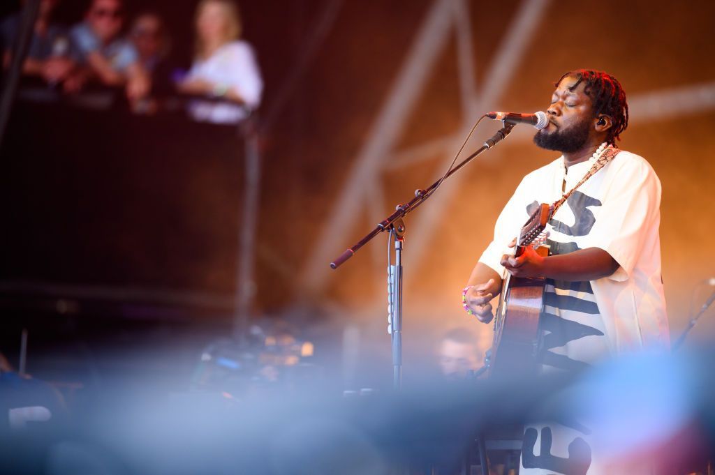 Michael Kiwanuka, dressed in a Ugandan Kunzu, plays on the Pyramid Stage at the Glastonbury Festival in June 2024.