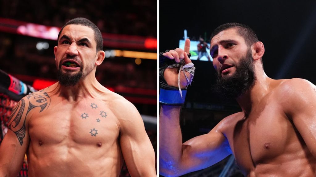 Robert Whittaker (L) celebrates beside a picture of Khamzat Chimaev doing the same