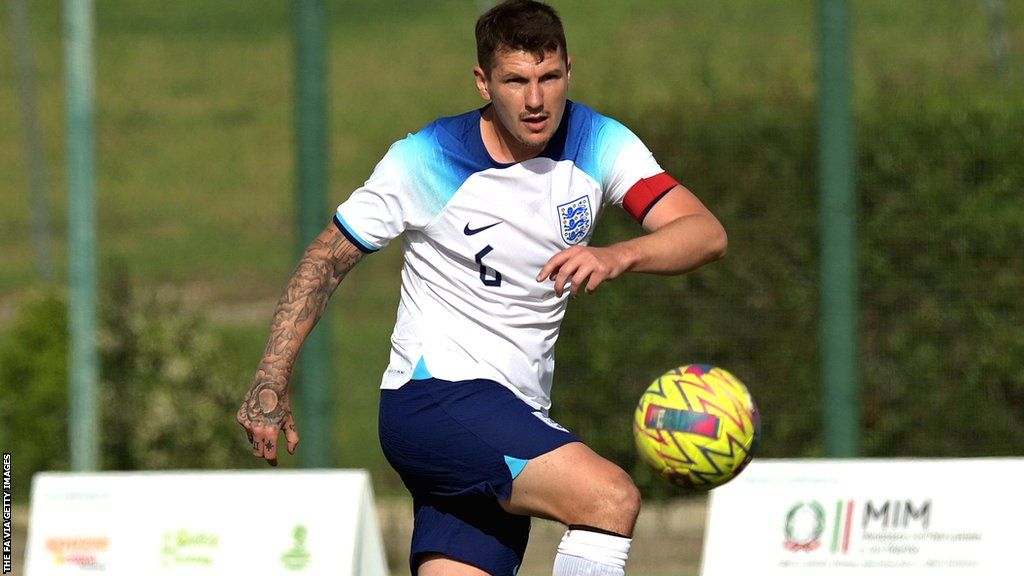 Matt Crossen controls the ball while playing for England