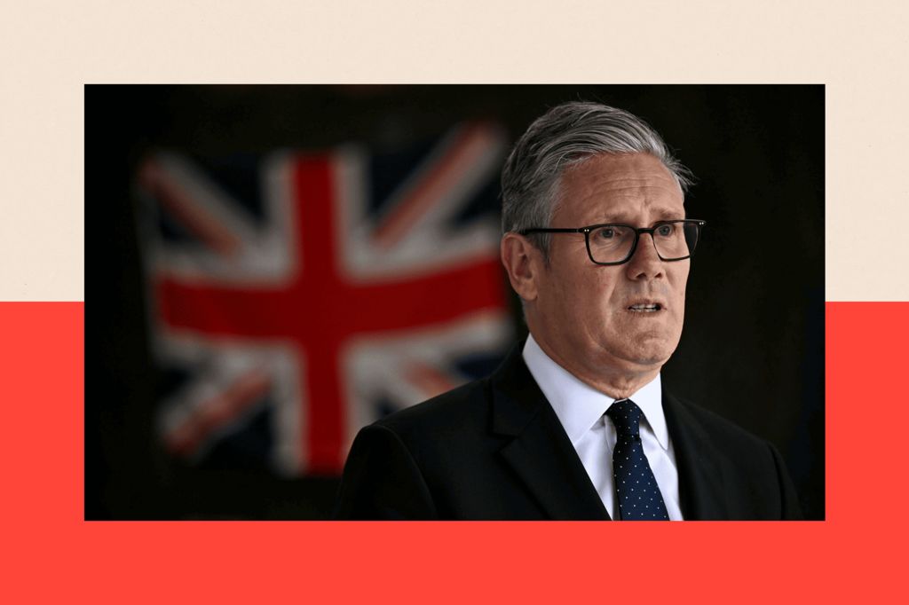 A close up of Sir Keir Starmer wearing glasses, with a UK flag in the background