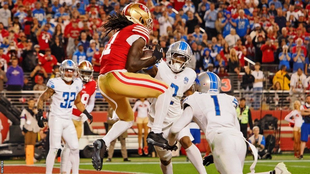 Brandon Aiyuk scores a touchdown against the Detroit Lions