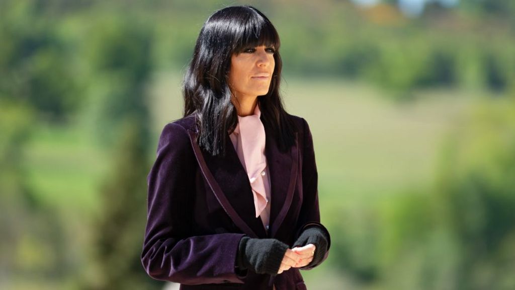 Claudia Winkleman pictured outdoors hosting series four of The Traitors