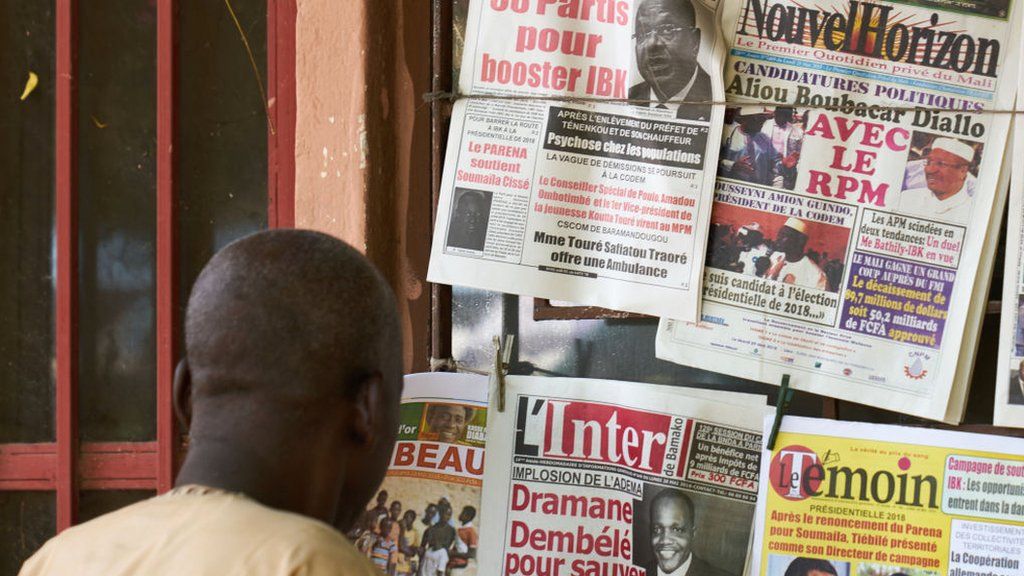 A man reads newspaper in Bamako on 28 May 2018 as Malia's president declared his candidacy for the next presidential elections