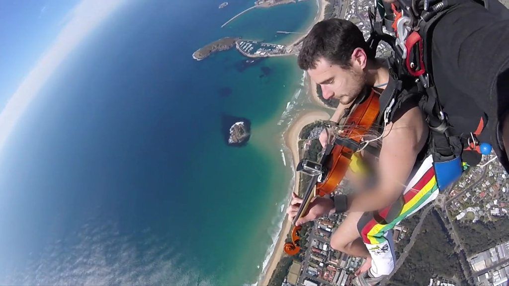 Glen Donnelly plays violin during naked skydive