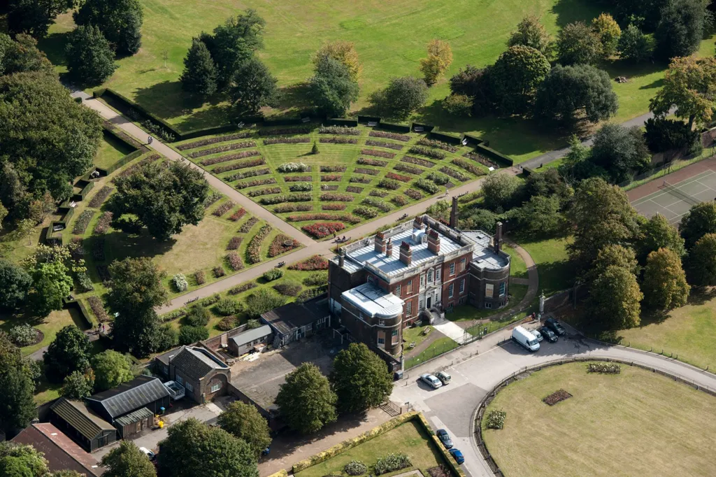 An aerial shot of Georgian mansion on the edge of Greenwich Park, showing lawns and a car park