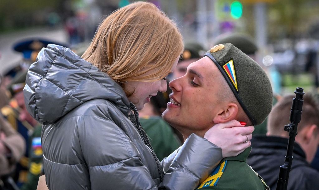 A Russian serviceman kisses his girlfriend