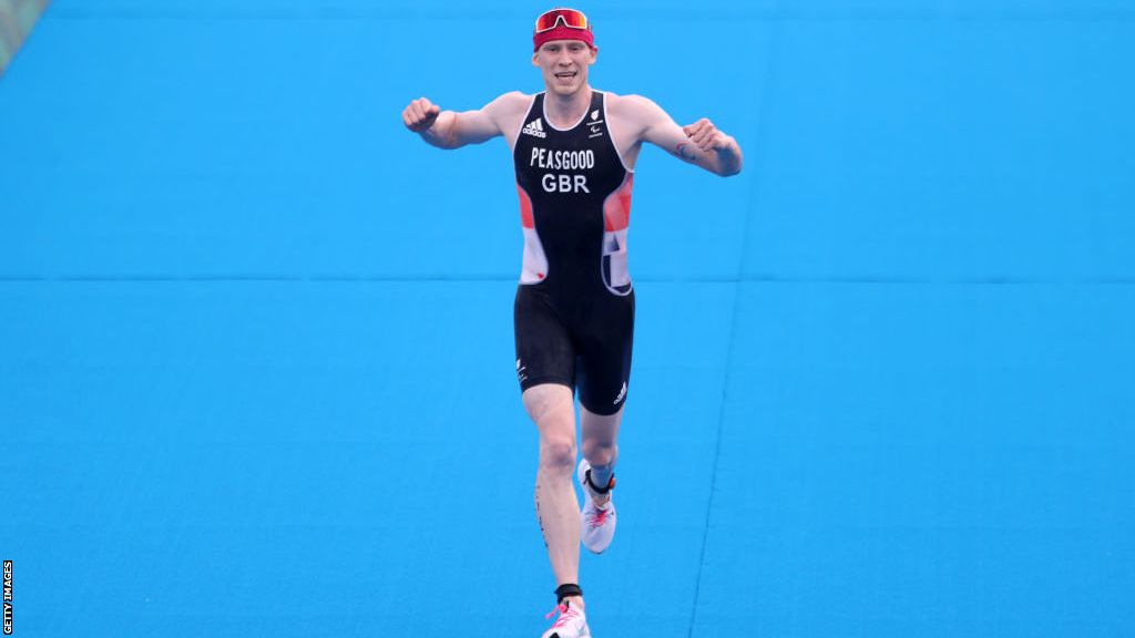 George Peasgood celebrates as he crosses the finish line of the Tokyo 2020 Paralympic triathlon