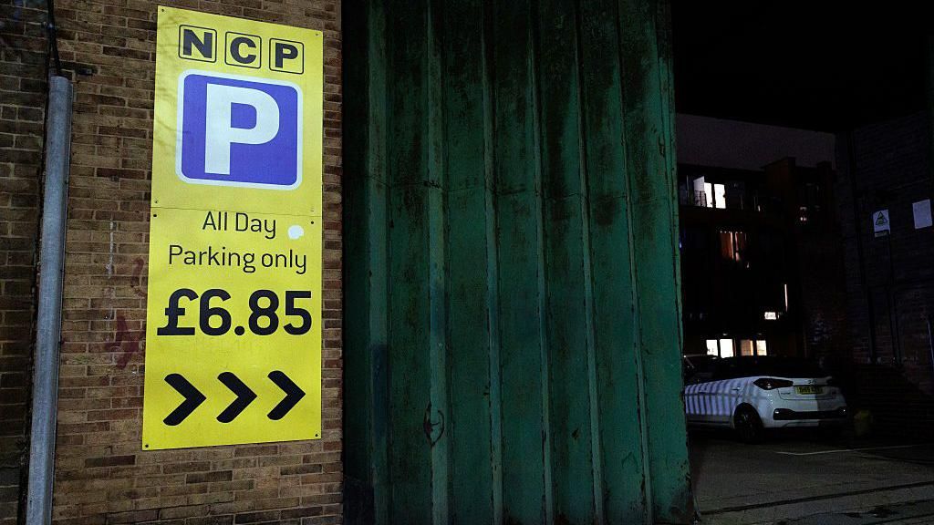 A yellow NCP sign saying "All Day Parking only £6.85"