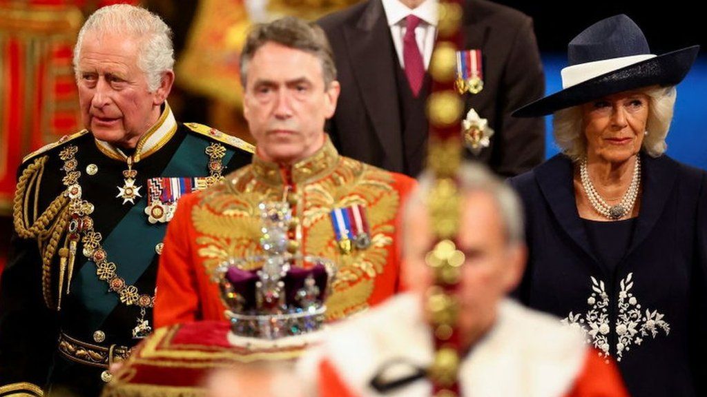 Prince Charles, Prince of Wales, Camilla, Duchess of Cornwall and Prince William proceed behind the Imperial State Crown through the Royal Gallery for the State Opening of Parliament in the House of Lords at the Palace of Westminster on 10 May 2022