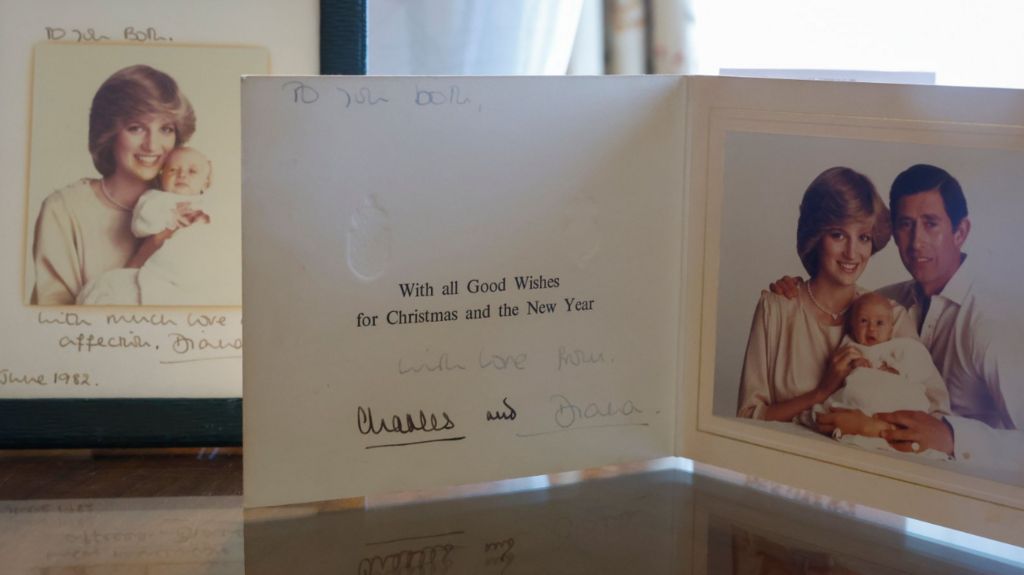 A 1982 signed photograph of Princess Diana and Prince William (L) and a 1993 signed holiday card with photo