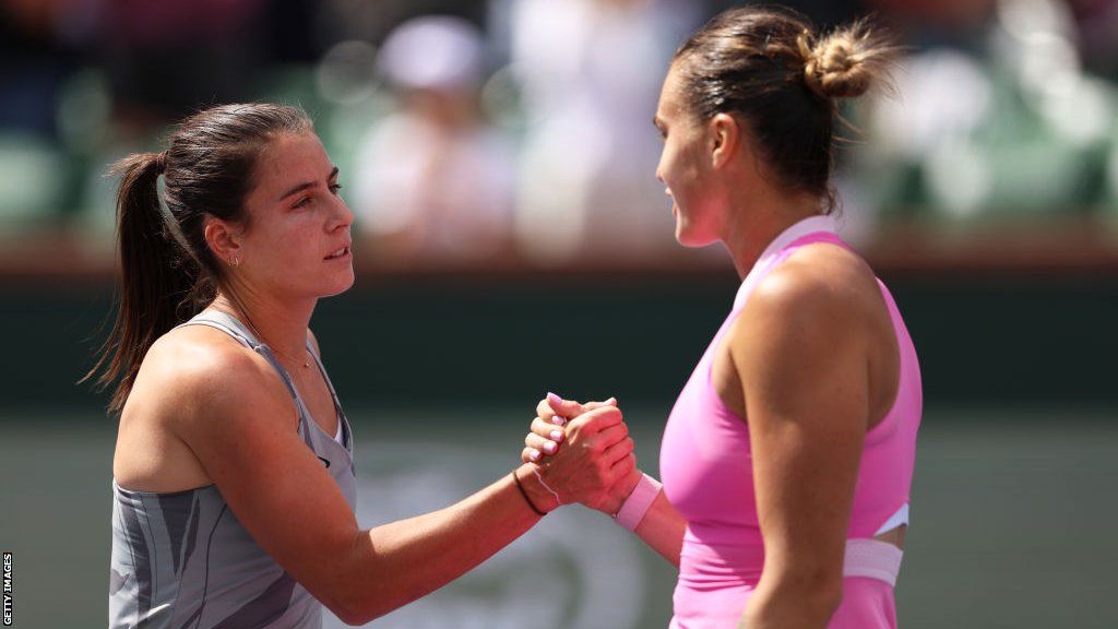 Emma Navarro of the United States shakes hands at the net after her three set victory against Aryna Sabalenka