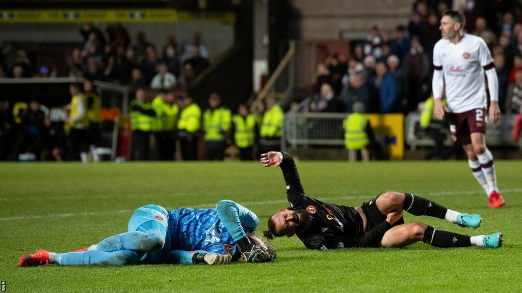 Hearts' Craig Gordon and Dundee United's Steven Fletcher lie injured