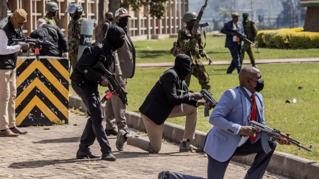 Kenya Police officers and security personnel take position to protect the Kenyan Parliament as protesters try to storm the building during a nationwide strike to protest against tax hikes and the Finance Bill 2024 in downtown Nairobi, on June 25, 2024