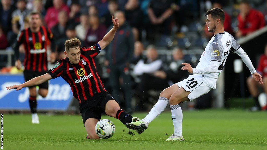 Liam Cullen of Swansea is tackled by David Brooks of Bournemouth