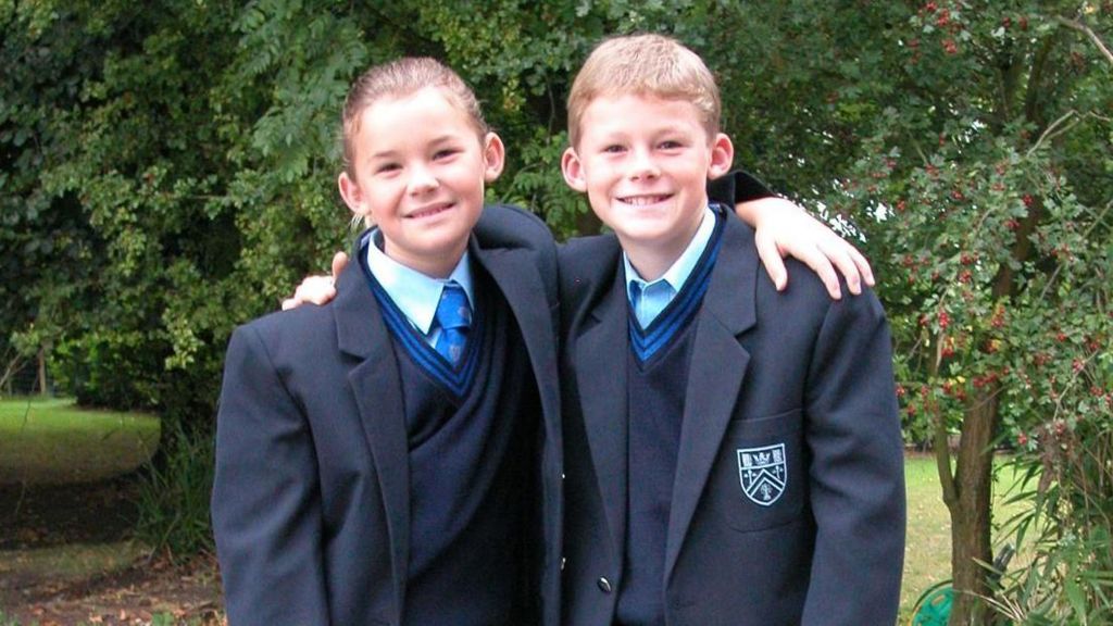 Ryan and Charlotte posing for a photo wearing their school uniform