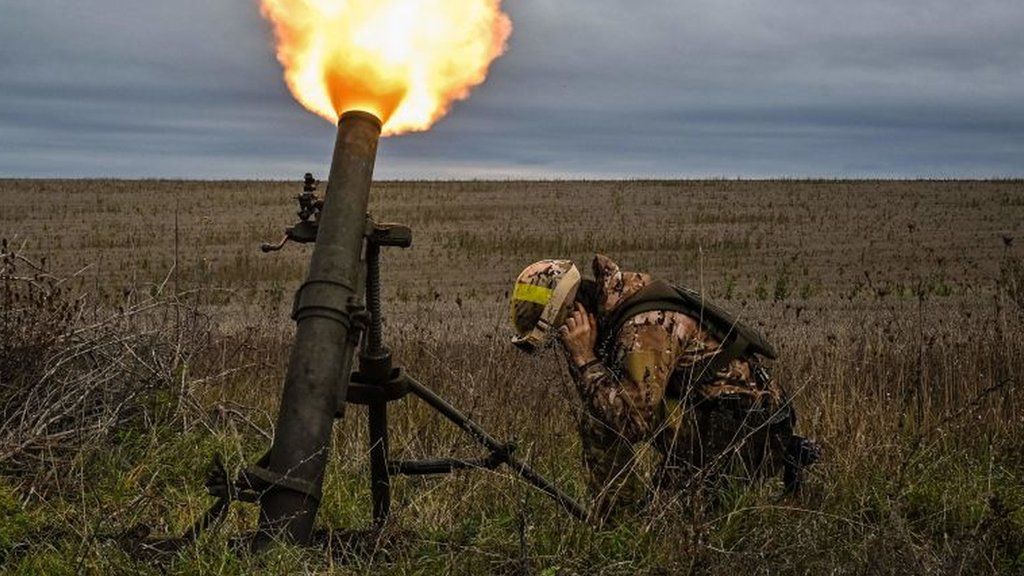 A Ukrainian soldier fires a mortar