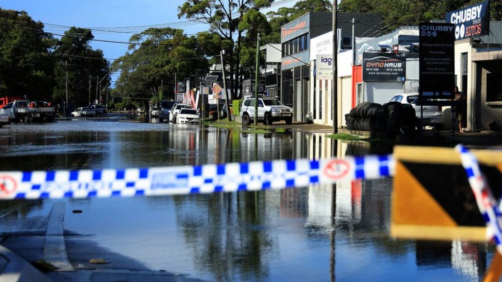 Police tape in front of a closed-off flooded road in the Sydney suburb of North Narrabeen on 6 April