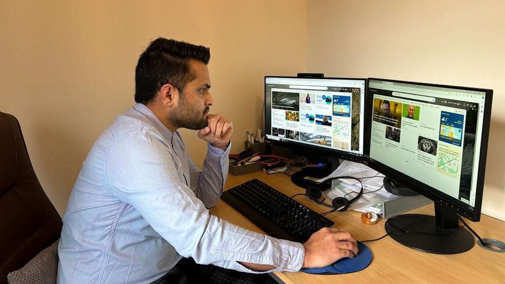 Kamrul Islam at his computer