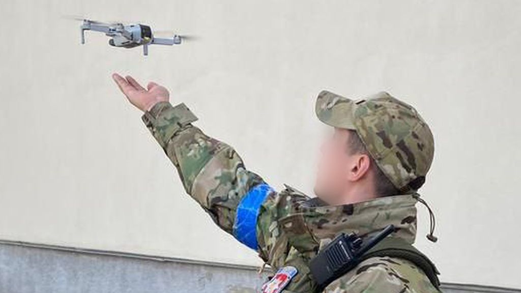 A Ukrainian soldier uses a small consumer drone