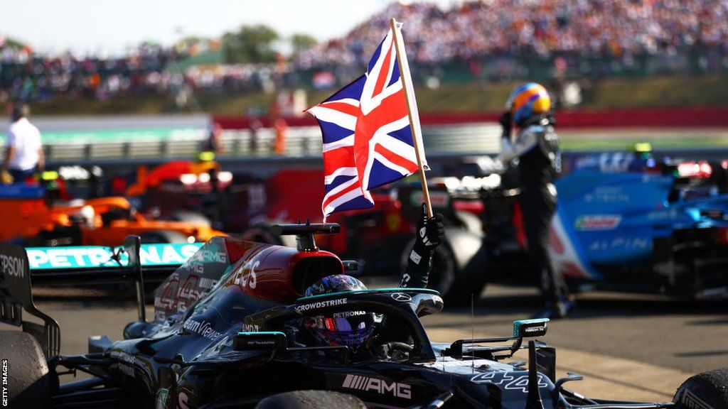 Lewis Hamilton celebrates with a union flag at Silverstone in 2021