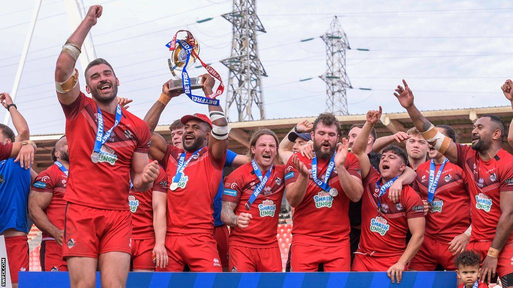 London Broncos celebrate their 2023 promotion final win with the trophy