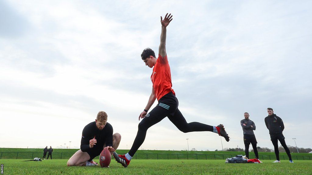Charlie Smyth kicks during a training session with Tadhg Leader