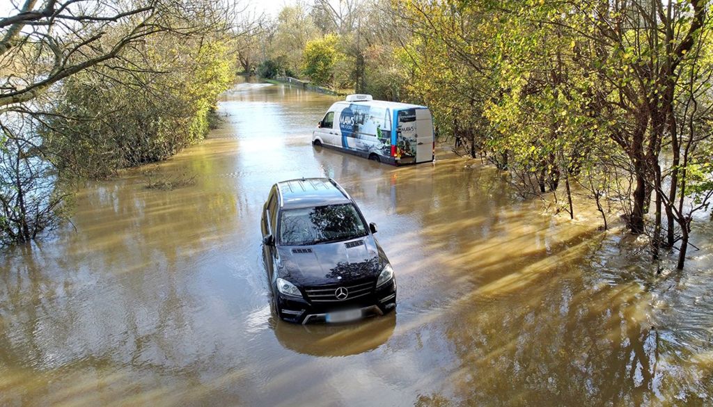 Vehicles were left stranded in floodwater from the River Adur near Shermanbury in West Sussex