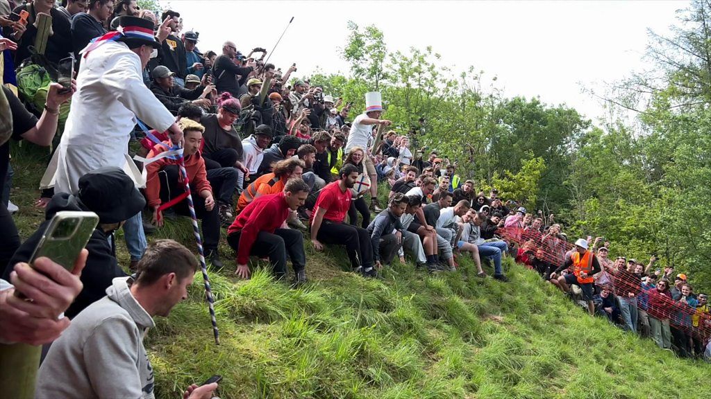 People wait at the start line on Coopers Hill for the cheese rolling race to begin