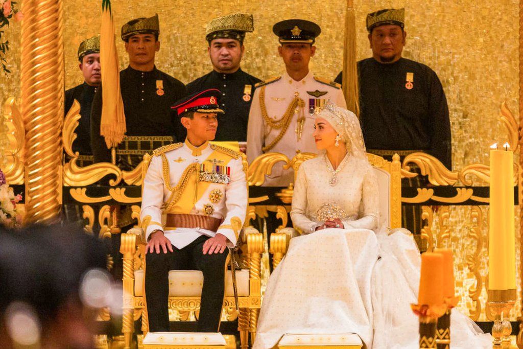 Prince Abdul Mateen and Yang Mulia Anisha Rosnah sit during their wedding reception at Istana Nurul Iman in Brunei's capital Bandar Seri Begawan