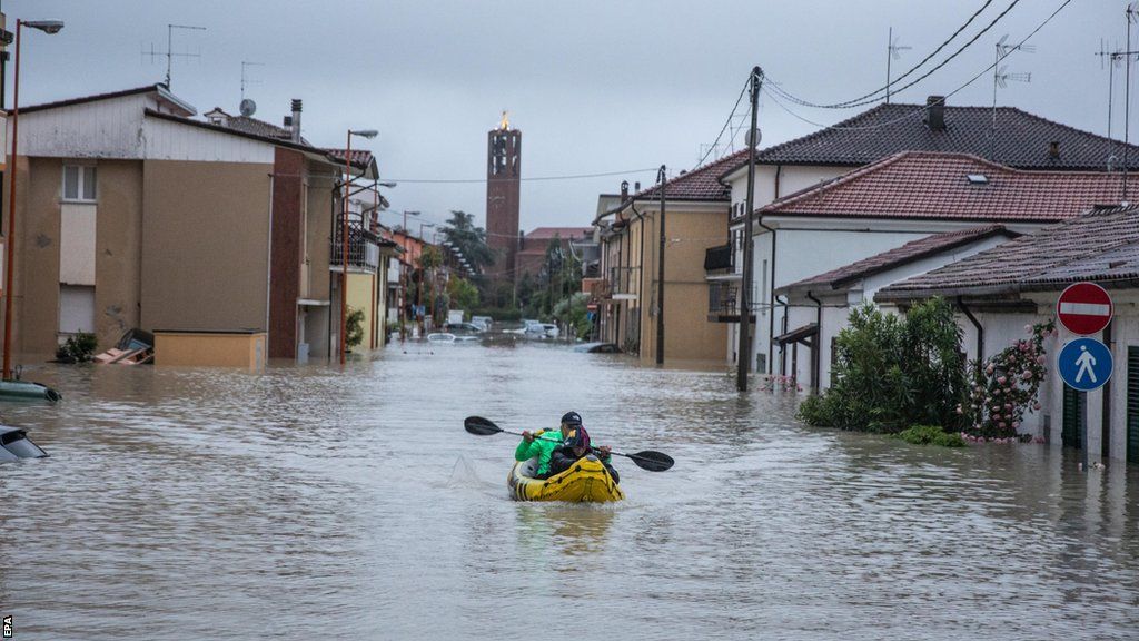Canoe on flooded street in Cesena, Italy