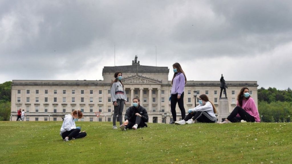Teenagers wearing masks outside Stormont