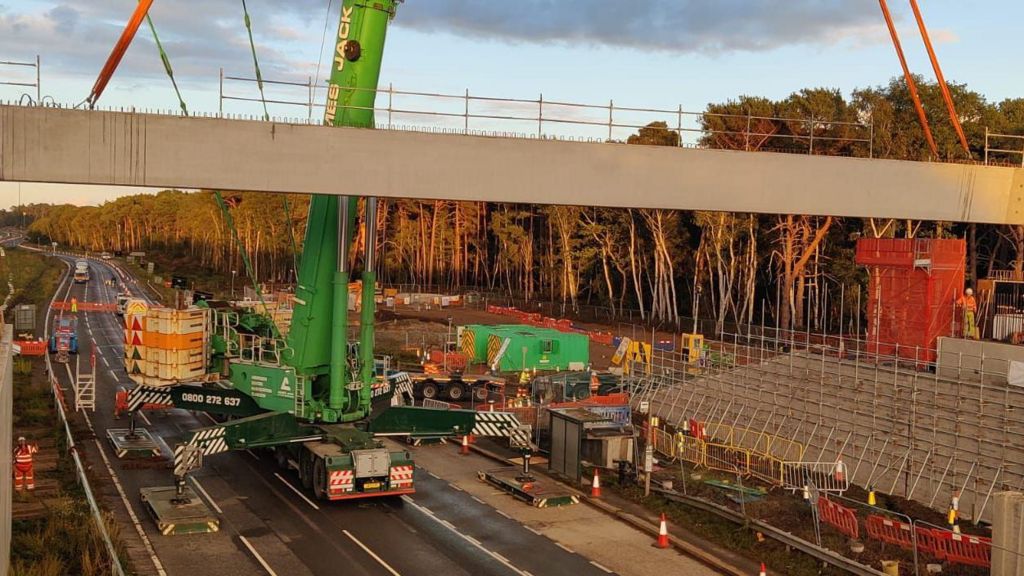 A construction site featuring a new concrete beam in place above the A3