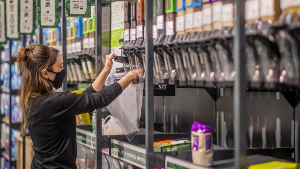 A person using a food refill station