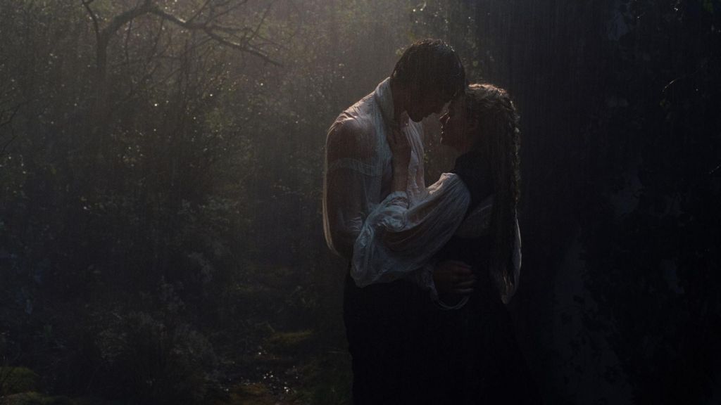 Jacob Elordi and Margot Robbie as Heathcliff and Cathy, embracing in the rain in a scene from the film