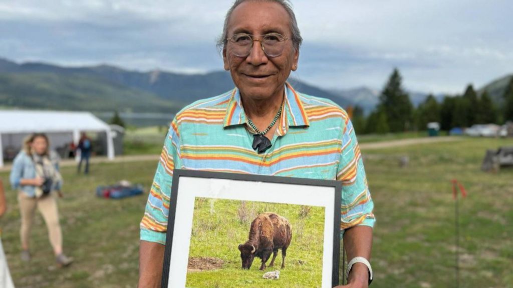 Chief Looking Horse holds a photo of the white bison