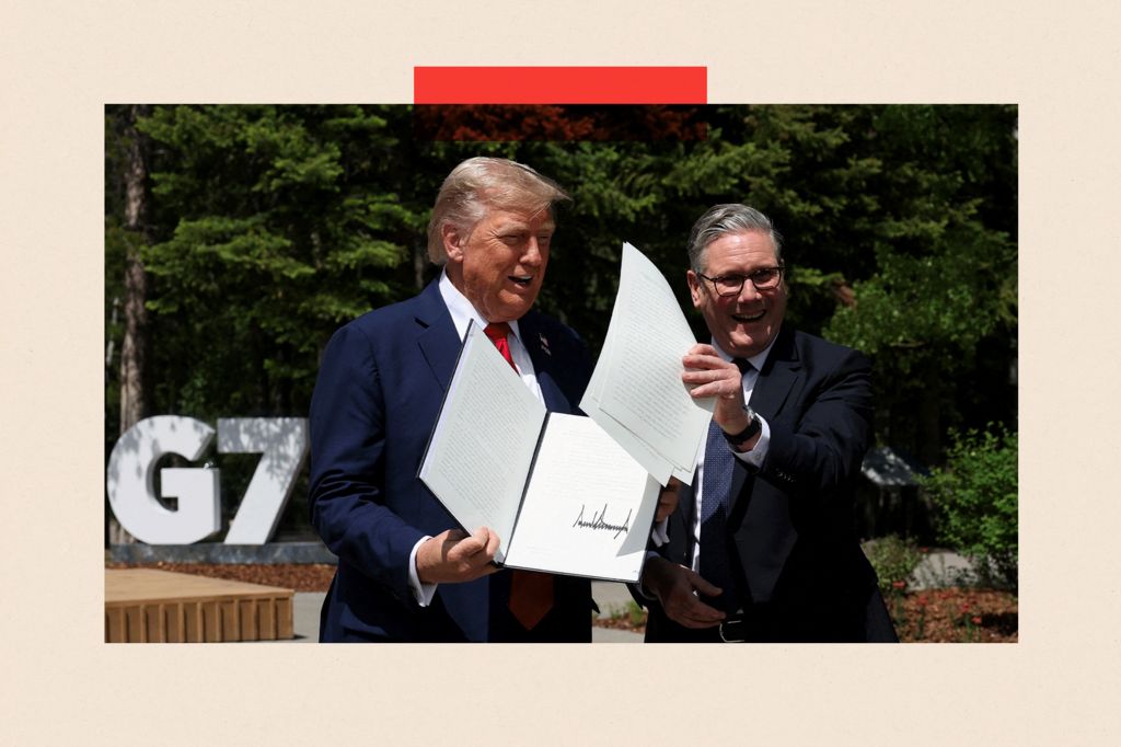 U.S. President Donald Trump and British Prime Minister Keir Starmer hold a signed Trade Agreement during a meeting at the G7 summit