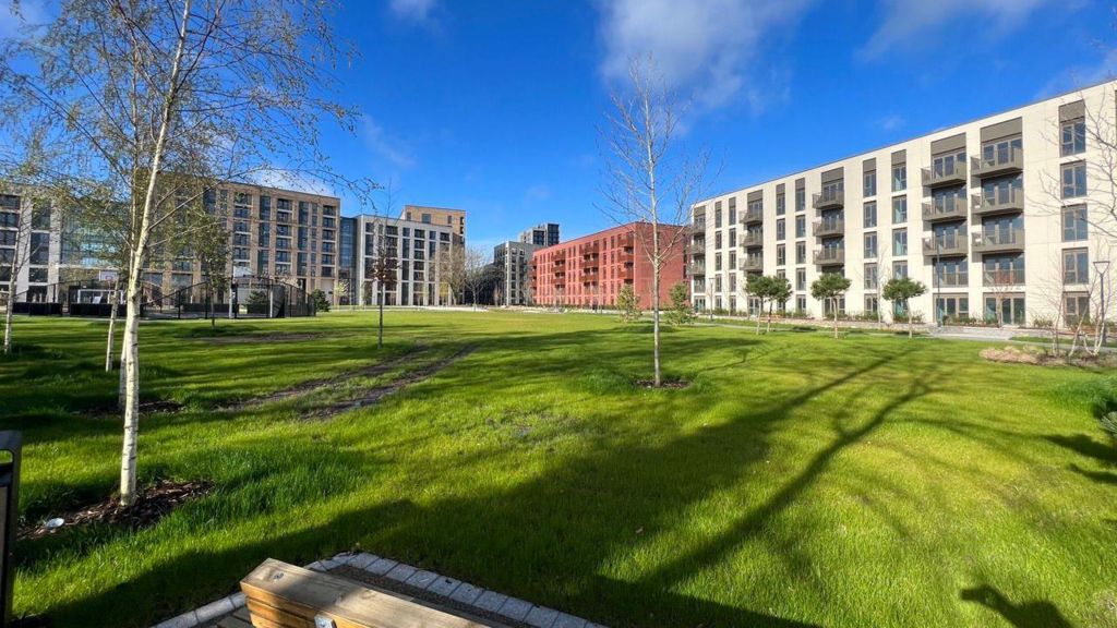 The outside of the Athletes' village with grass and trees