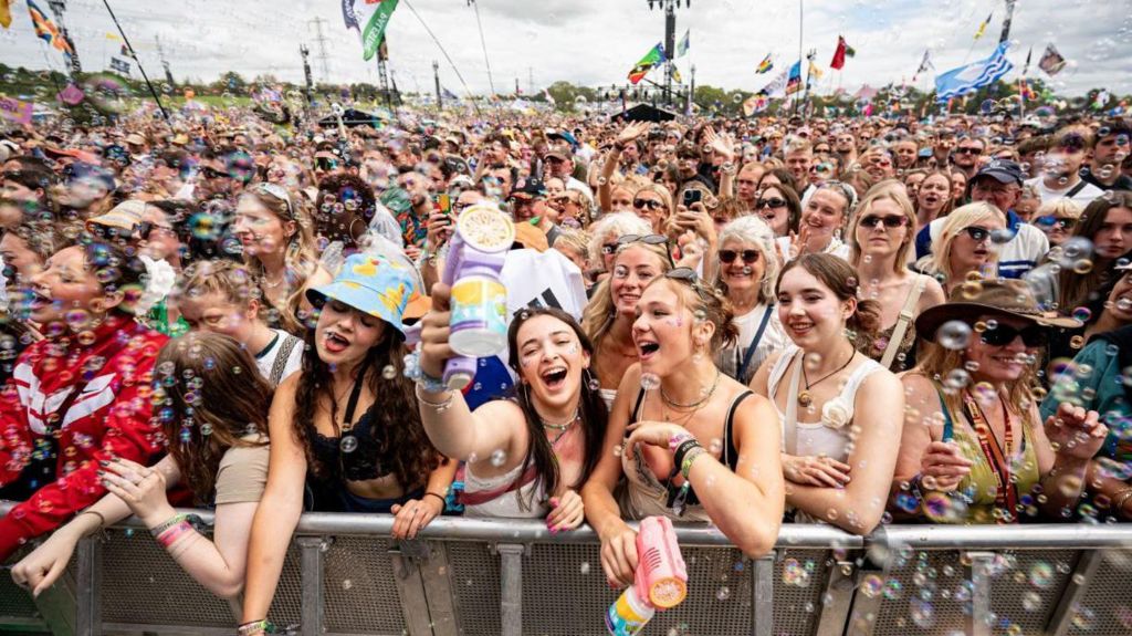 A crowd of people watching music at the Pyramid Stage.