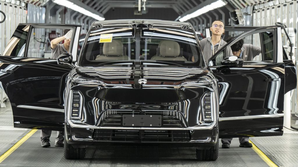 Employees inspect a Nio Inc. ES9 electric vehicle on the production line at the company's factory in Hefei, Anhui Province, China, on Tuesday, May 19, 2026.