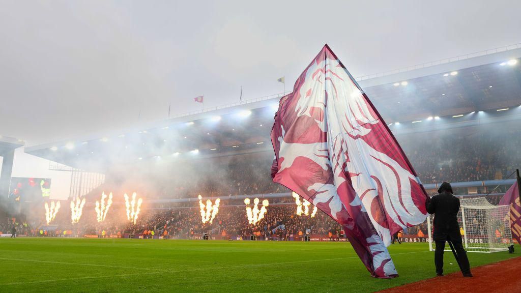 Aston Villa fan flying a flag at Villa Park